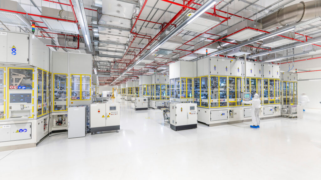 Innenansicht der PowerCo-Gigafabrik in Salzgitter mit hochautomatisierten Produktionsanlagen für Batteriezellen und Mitarbeitenden im Reinraum.